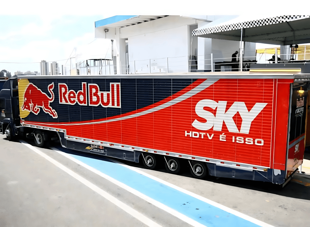 A imagem demonstra a carreta RedBull estacionada em frente a fábrica.